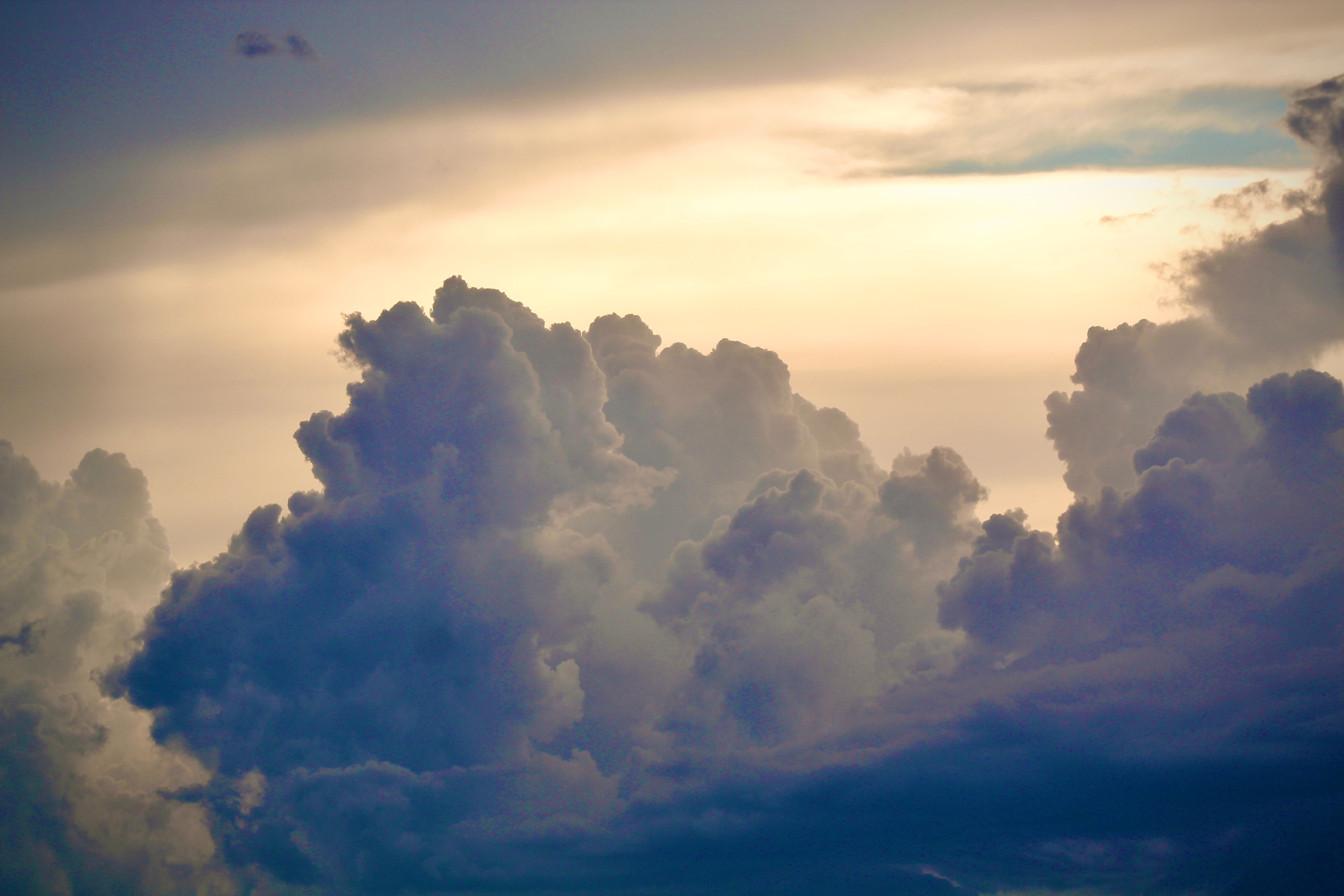 Dramatic clouds lit from behind at golden hour