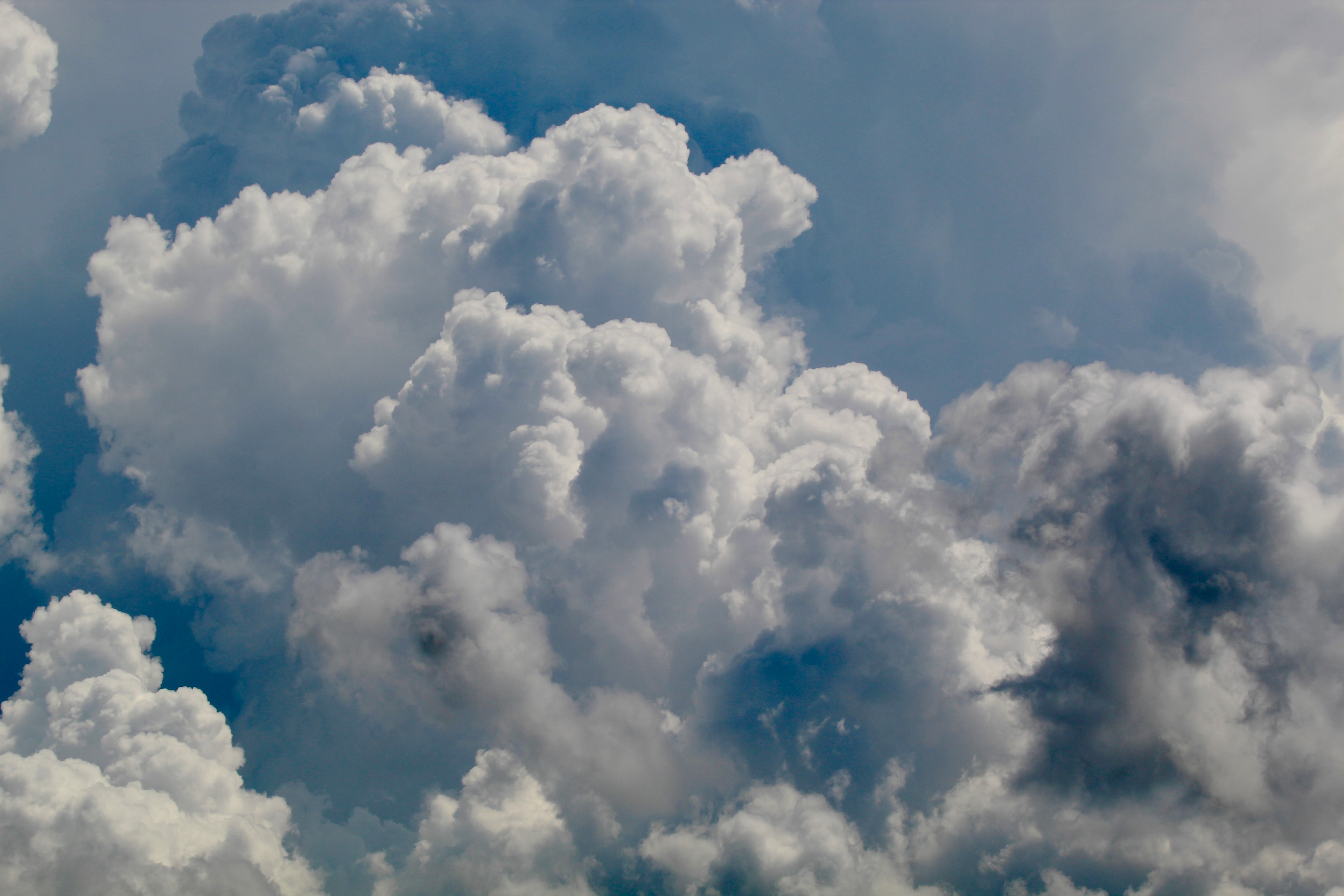 Towering cumulus clouds in a deep blue summer sky
